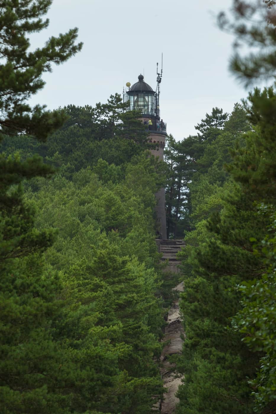 Czołpino lighthouse seen from the Słowiński National Park side among pine trees